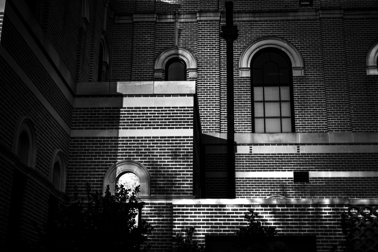 Lit windows at night, figures working inside
