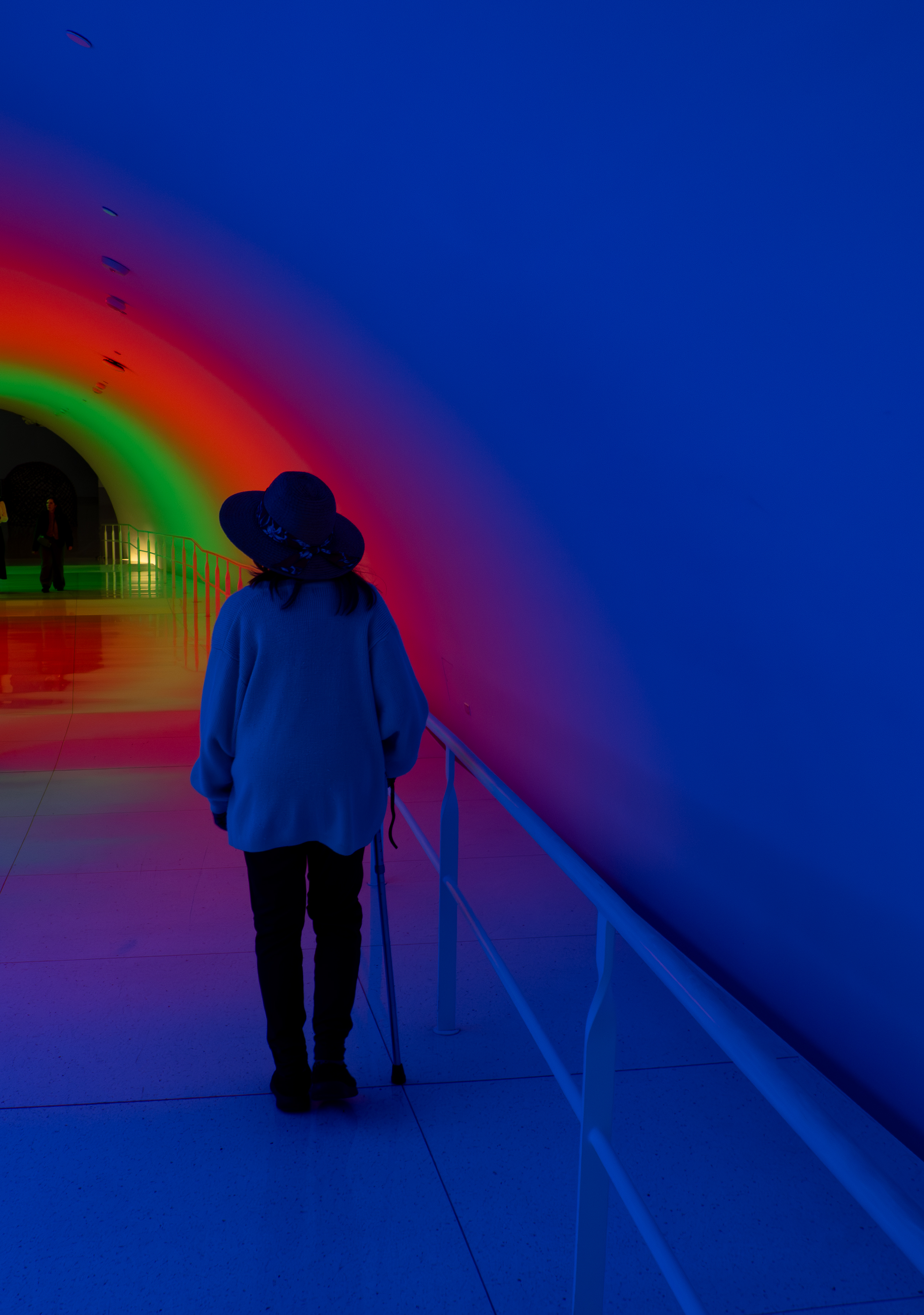 Figure in rainbow light installation